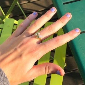 A white and green stone and a clear stone ring